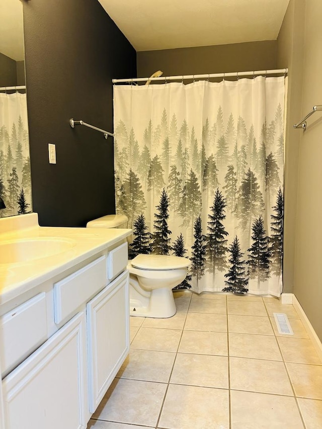 full bathroom featuring tile patterned flooring, visible vents, toilet, and vanity