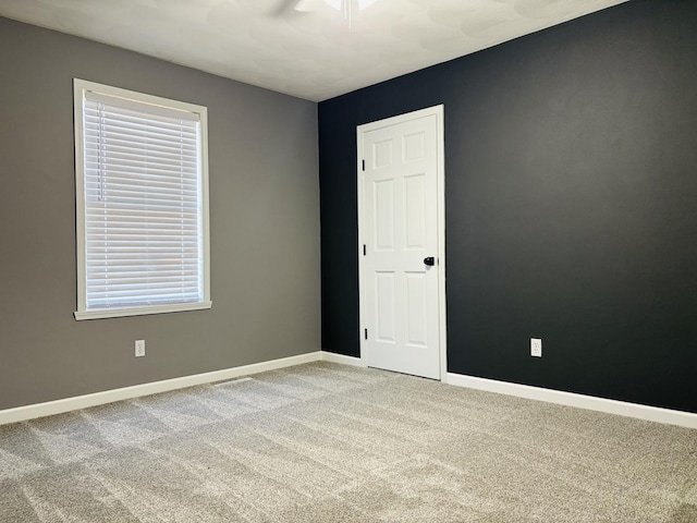 carpeted empty room with baseboards