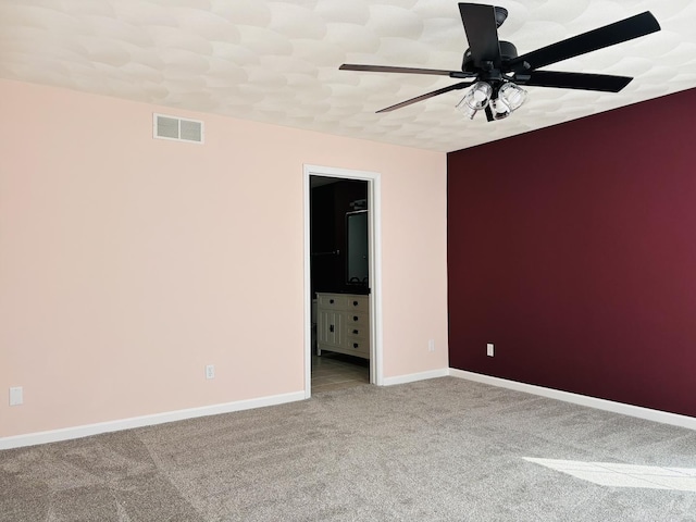 spare room with visible vents, ceiling fan, baseboards, and carpet floors