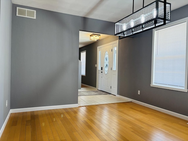 entrance foyer featuring hardwood / wood-style flooring, baseboards, and visible vents