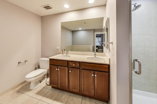 bathroom with a shower stall, toilet, visible vents, and a sink