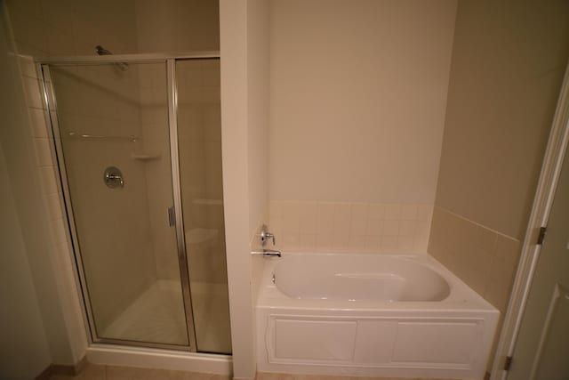 bathroom with a garden tub and a stall shower