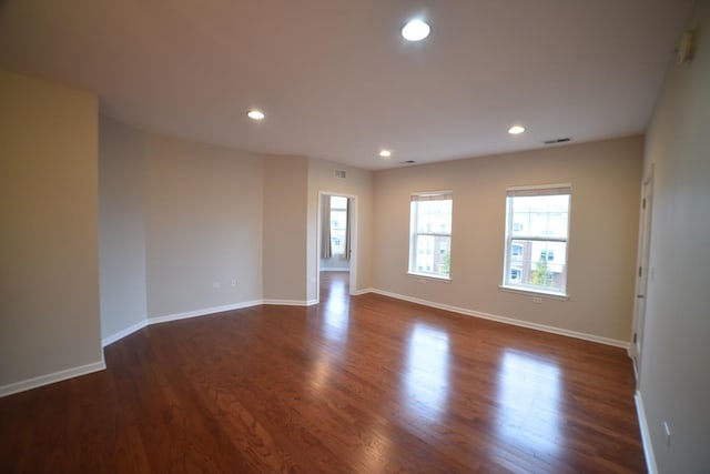 unfurnished room featuring recessed lighting, visible vents, baseboards, and dark wood-style flooring