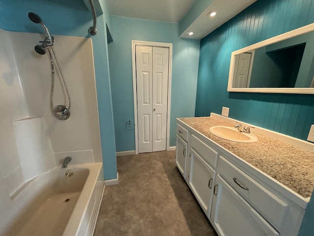 bathroom with baseboards, bathtub / shower combination, and vanity