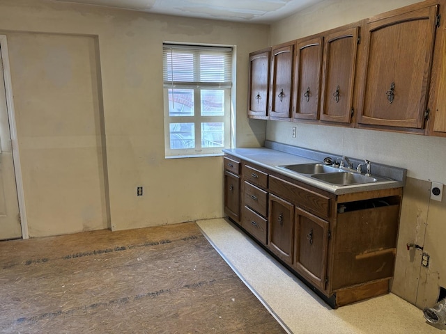 kitchen featuring a sink and light countertops