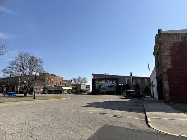 view of street featuring curbs, street lights, and sidewalks