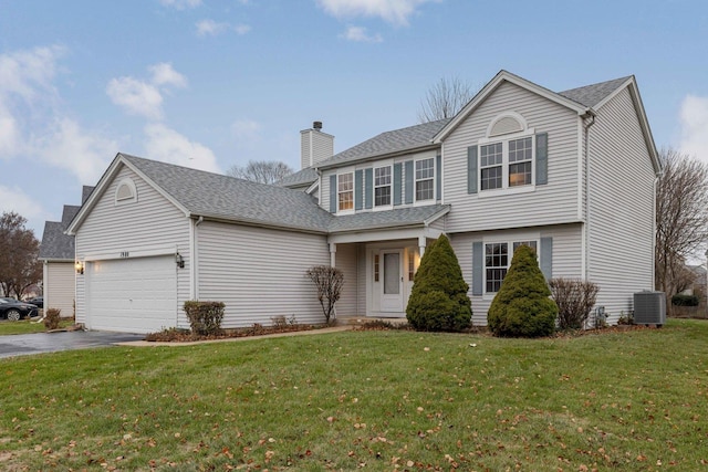 view of front of house featuring a garage, central AC unit, driveway, and a front yard