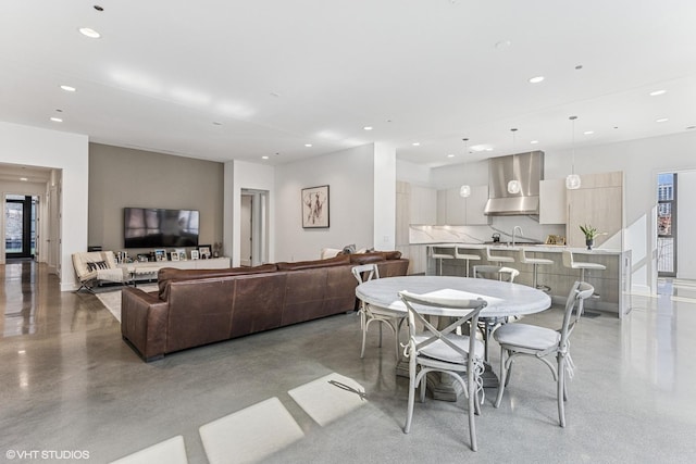 dining space featuring recessed lighting and finished concrete floors