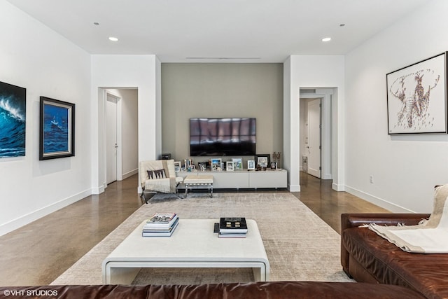 living area with recessed lighting, baseboards, and concrete flooring