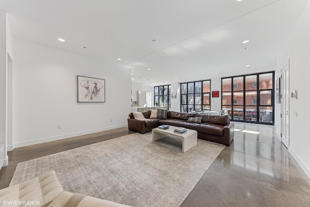 living room with recessed lighting, expansive windows, and baseboards