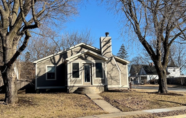 view of front of property featuring a chimney and fence