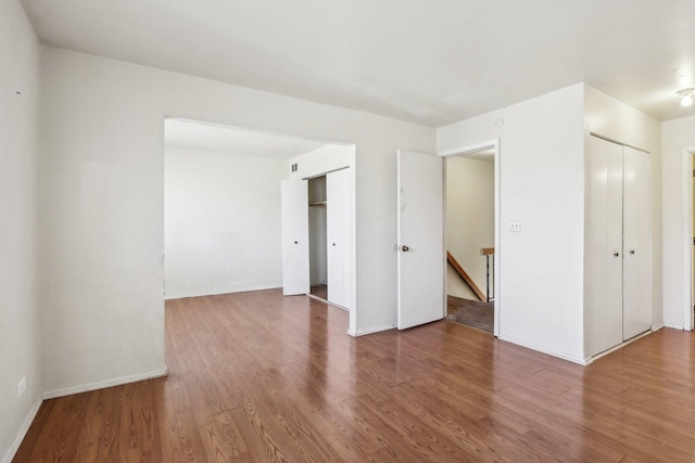 unfurnished room featuring wood finished floors and baseboards