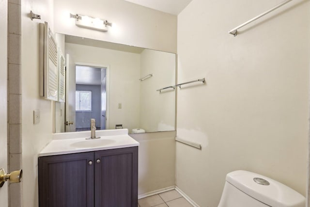 half bath featuring toilet, vanity, and tile patterned flooring