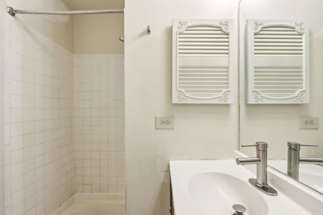 full bath featuring vanity, radiator, and a stall shower