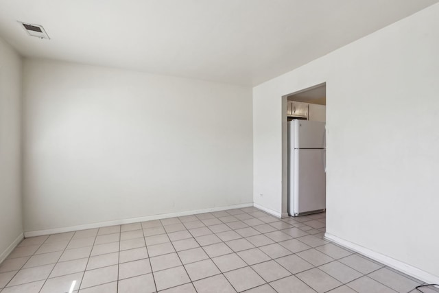 unfurnished room with visible vents and baseboards