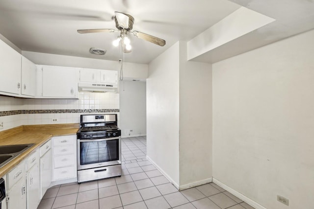 kitchen with light tile patterned floors, visible vents, decorative backsplash, under cabinet range hood, and gas range