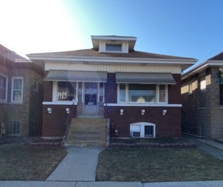 bungalow-style home featuring brick siding