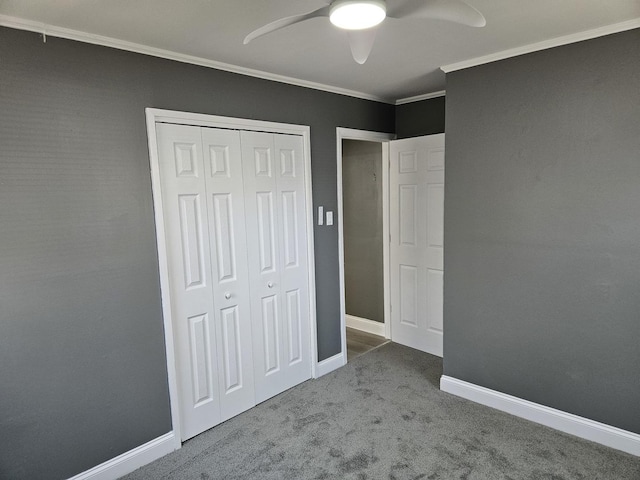 unfurnished bedroom with crown molding, ceiling fan, baseboards, carpet flooring, and a closet