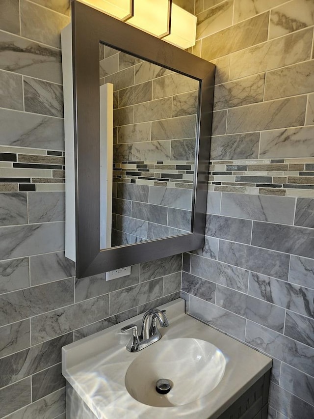 bathroom with tasteful backsplash, tile walls, and vanity