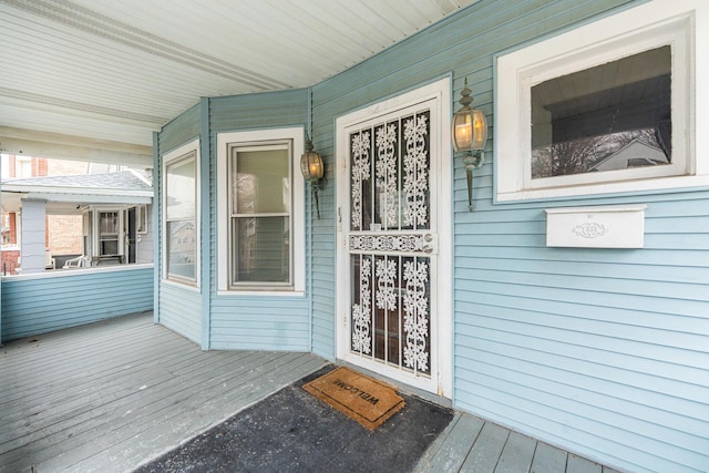 view of exterior entry with a porch