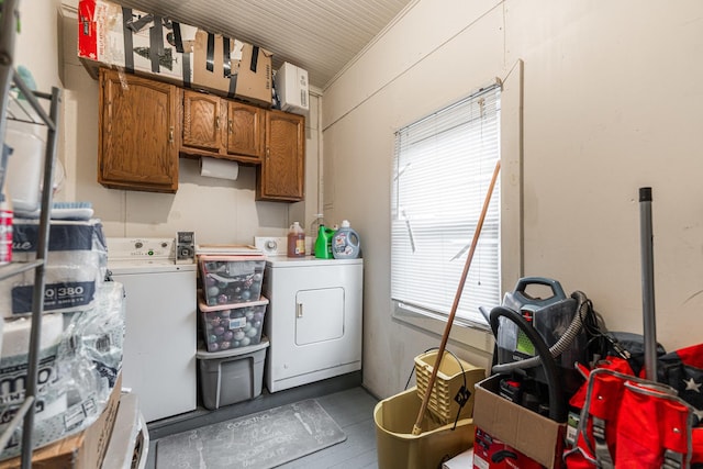 washroom featuring cabinet space and separate washer and dryer