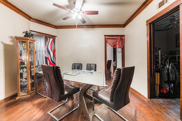 dining area with crown molding, visible vents, wood-type flooring, and ceiling fan
