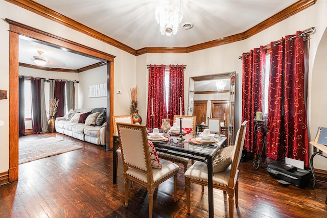 dining area featuring visible vents, hardwood / wood-style floors, and ornamental molding