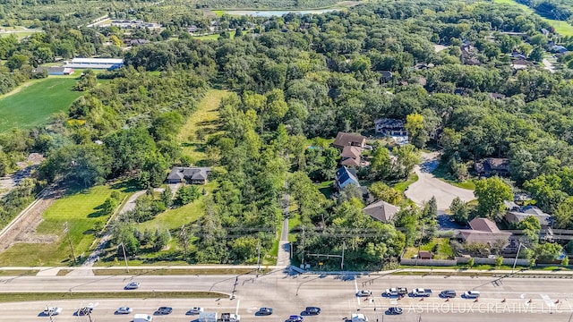 birds eye view of property featuring a view of trees