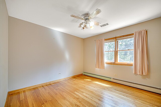 unfurnished room featuring visible vents, a ceiling fan, wood-type flooring, baseboards, and baseboard heating