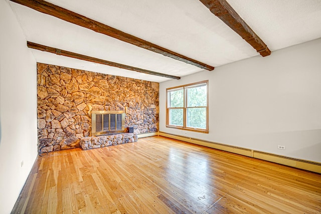 unfurnished living room featuring beamed ceiling, a fireplace, baseboards, and wood-type flooring