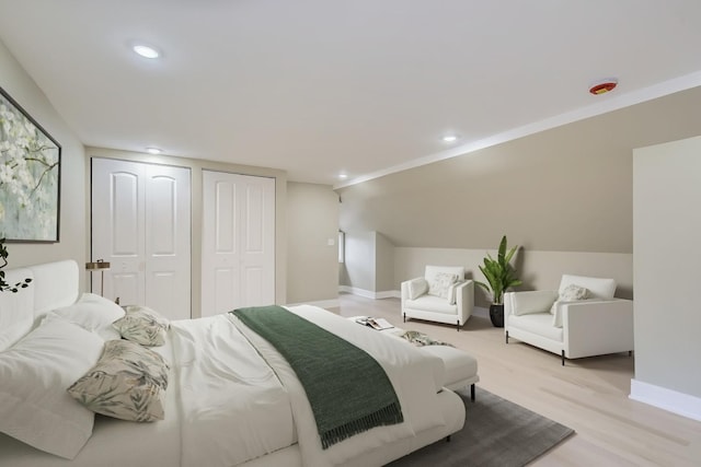 8217 S Woodlawn Ave, Chicago, IL 60619 - bedroom featuring light wood finished floors, multiple closets, baseboards, vaulted ceiling, and recessed lighting