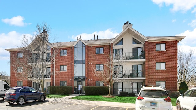 view of property featuring uncovered parking