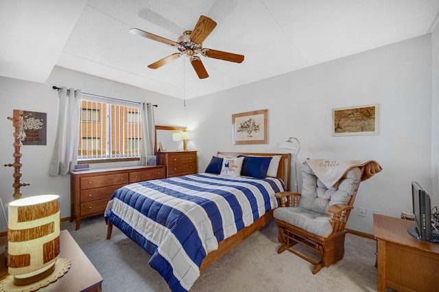 bedroom featuring baseboards, light colored carpet, and ceiling fan