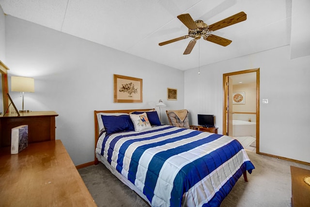 bedroom featuring ensuite bath, a ceiling fan, baseboards, and carpet floors