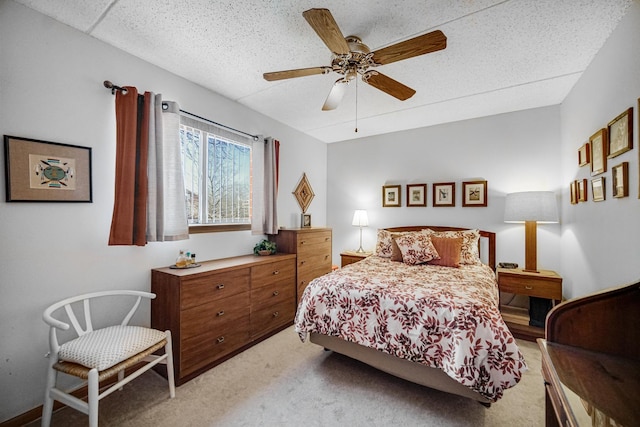 bedroom with light colored carpet and a ceiling fan