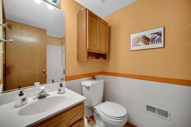 bathroom featuring visible vents, toilet, and vanity