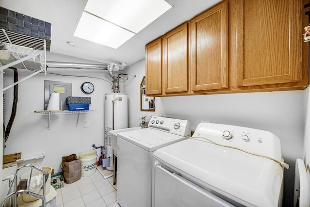 washroom with tile patterned flooring, washer and clothes dryer, gas water heater, a skylight, and cabinet space