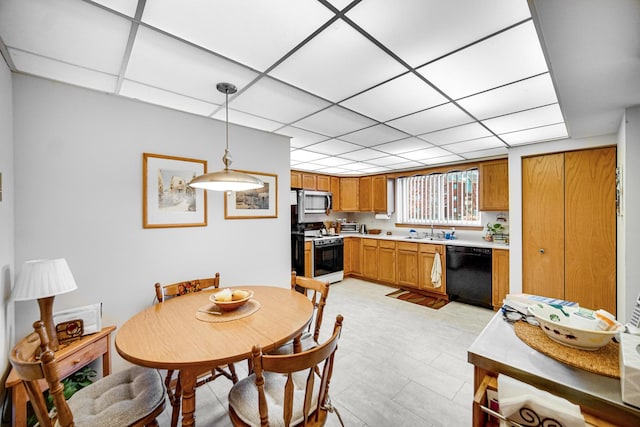 dining room featuring a drop ceiling