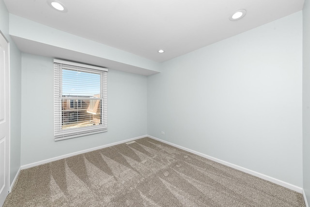 spare room with carpet flooring, recessed lighting, and baseboards