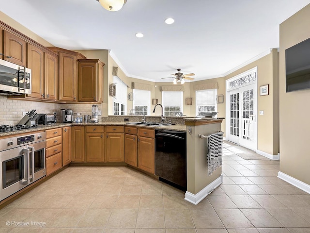 kitchen with light tile patterned floors, a peninsula, a sink, stainless steel appliances, and backsplash