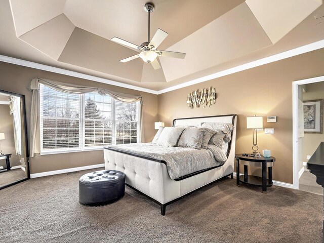 bedroom with ceiling fan, baseboards, a raised ceiling, and carpet