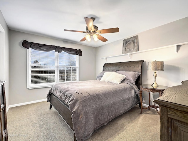 carpeted bedroom with baseboards and ceiling fan