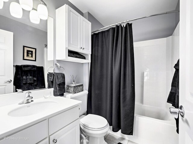 bathroom featuring tile patterned flooring, shower / bath combination with curtain, toilet, and vanity