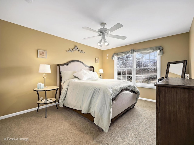 carpeted bedroom featuring baseboards and ceiling fan