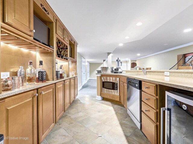 kitchen with light stone countertops, recessed lighting, a sink, wine cooler, and appliances with stainless steel finishes