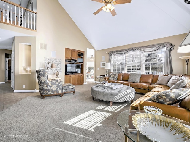 living area featuring a ceiling fan, baseboards, visible vents, high vaulted ceiling, and light colored carpet