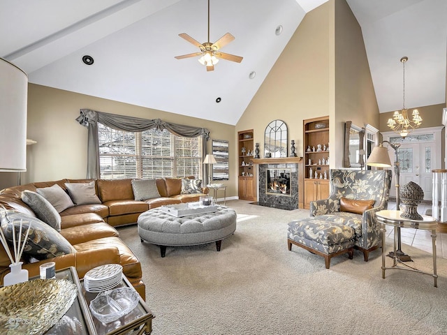 living room featuring ceiling fan with notable chandelier, a fireplace, carpet floors, and high vaulted ceiling