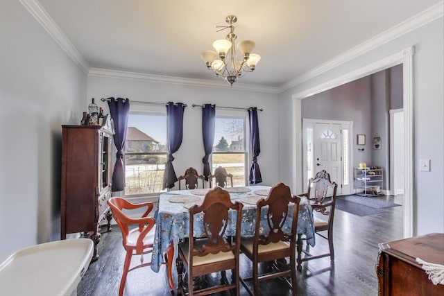 dining room featuring an inviting chandelier, wood finished floors, and ornamental molding