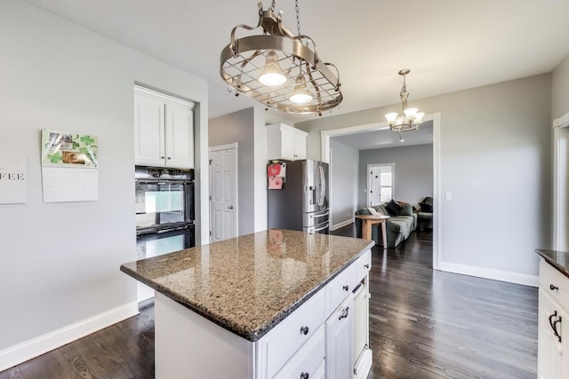 kitchen featuring dark wood-style flooring, dobule oven black, an inviting chandelier, and stainless steel fridge with ice dispenser