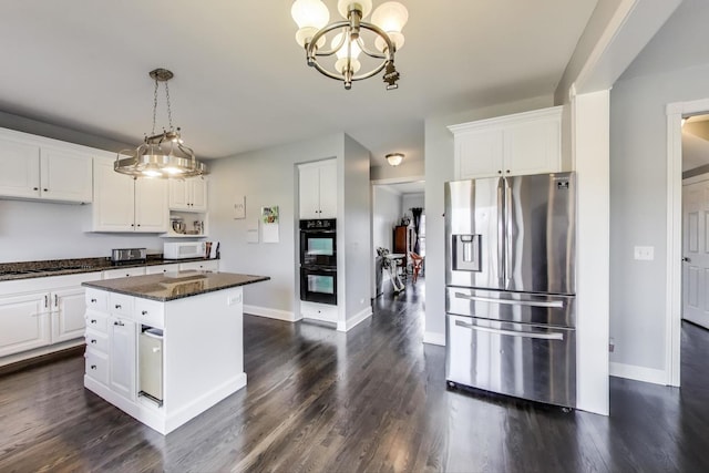 kitchen featuring dobule oven black, dark wood-style floors, stainless steel refrigerator with ice dispenser, and white cabinetry